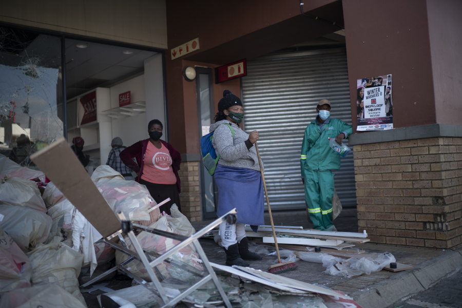 Volunteers participate in the cleaning efforts at Soweto's Diepkloof mall outside Johannesburg, South Africa, Thursday July 15, 2021. A massive cleaning effort has started following days of violence in Gauteng and KwaZulu-Natal provinces.