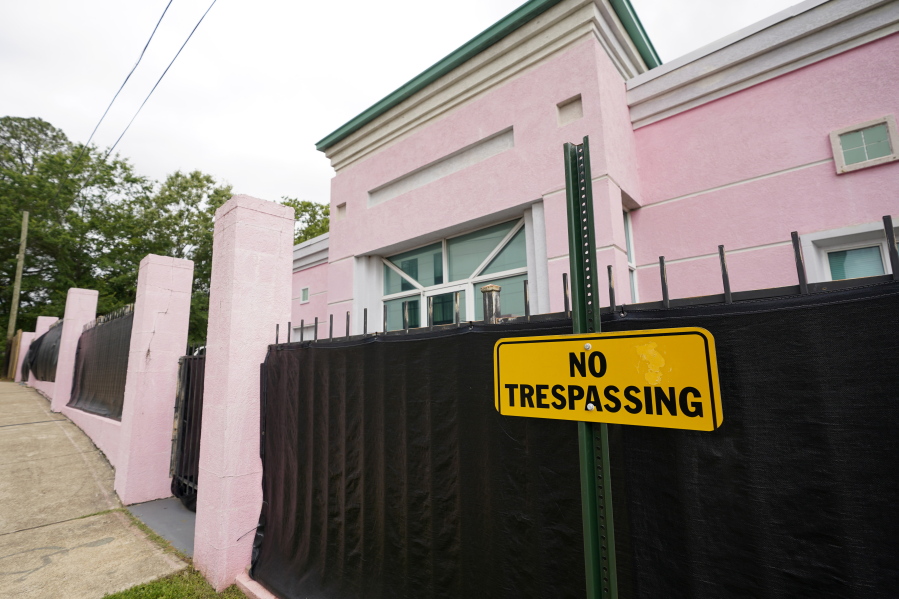 FILE - In this May 19, 2021, file photo, the Jackson Women's Health Organization clinic, more commonly known as "The Pink House," is shrouded with a black tarp so that its clients may enter in privacy in Jackson, Miss. The Mississippi attorney general's office is expected to file briefs with the U.S. Supreme Court on Thursday to outline the state's arguments in a case that could upend nearly 50 years of court rulings on abortion rights nationwide. (AP Photo/Rogelio V.