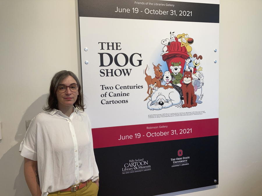 Anne Drozd, museum coordinator at Ohio State University's Billy Ireland Cartoon Library Museum, stands at the entrance to the library's new exhibit, "The Dog Show," on Thursday, June 24, 2021, in Columbus, Ohio. Drozd said the genesis for the exhibit came when the late Brad Anderson, the creator of Marmaduke, donated his collection in 2018, including 16,000 original Marmaduke cartoons from 1954 to 2010.