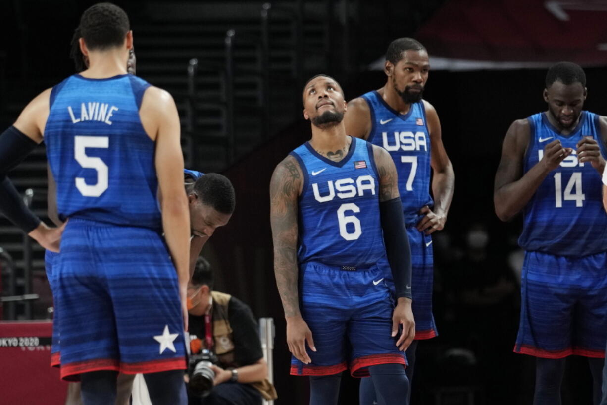United States' Damian Lillard (6), Kevin Durant (7), and Draymond Green (16) their loss to France in wait for play to resume during their loss to France in a men's basketball preliminary round game at the 2020 Summer Olympics, Sunday, July 25, 2021, in Saitama, Japan.