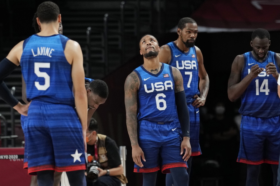 United States' Damian Lillard (6), Kevin Durant (7), and Draymond Green (16) their loss to France in wait for play to resume during their loss to France in a men's basketball preliminary round game at the 2020 Summer Olympics, Sunday, July 25, 2021, in Saitama, Japan.