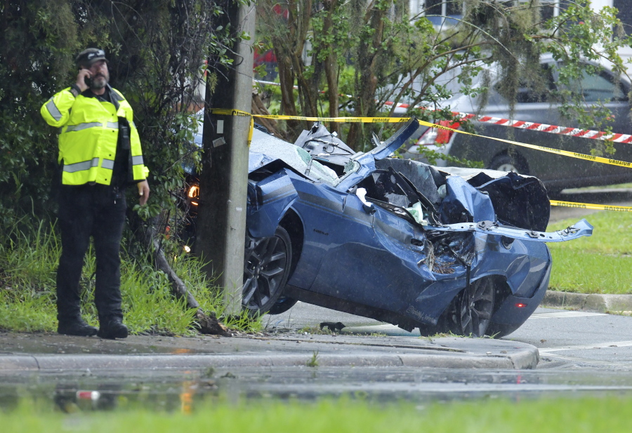 Law enforcement investigators in the scene of a fatal car crash on Roosevelt Blvd. in the Ortega neighborhood of Jacksonville, Fla. during the strong winds from Tropical Storm Elsa, Wednesday, July 7, 2021.