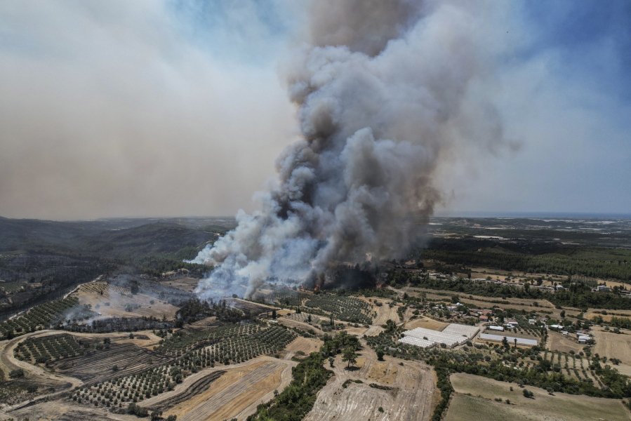 An aerial photo shows wildfires in Kacarlar village near the Mediterranean coastal town of Manavgat, Antalya, Turkey, Saturday, July 31, 2021. The death toll from wildfires raging in Turkey's Mediterranean towns rose to six Saturday after two forest workers were killed, the country's health minister said. Fires across Turkey since Wednesday burned down forests, encroaching on villages and tourist destinations and forcing people to evacuate.