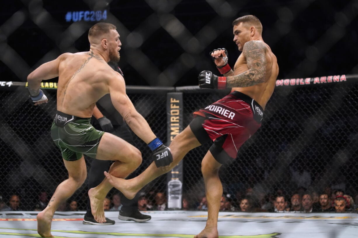 Dustin Poirier, right, kicks Conor McGregor during a UFC 264 lightweight mixed martial arts bout Saturday, July 10, 2021, in Las Vegas.