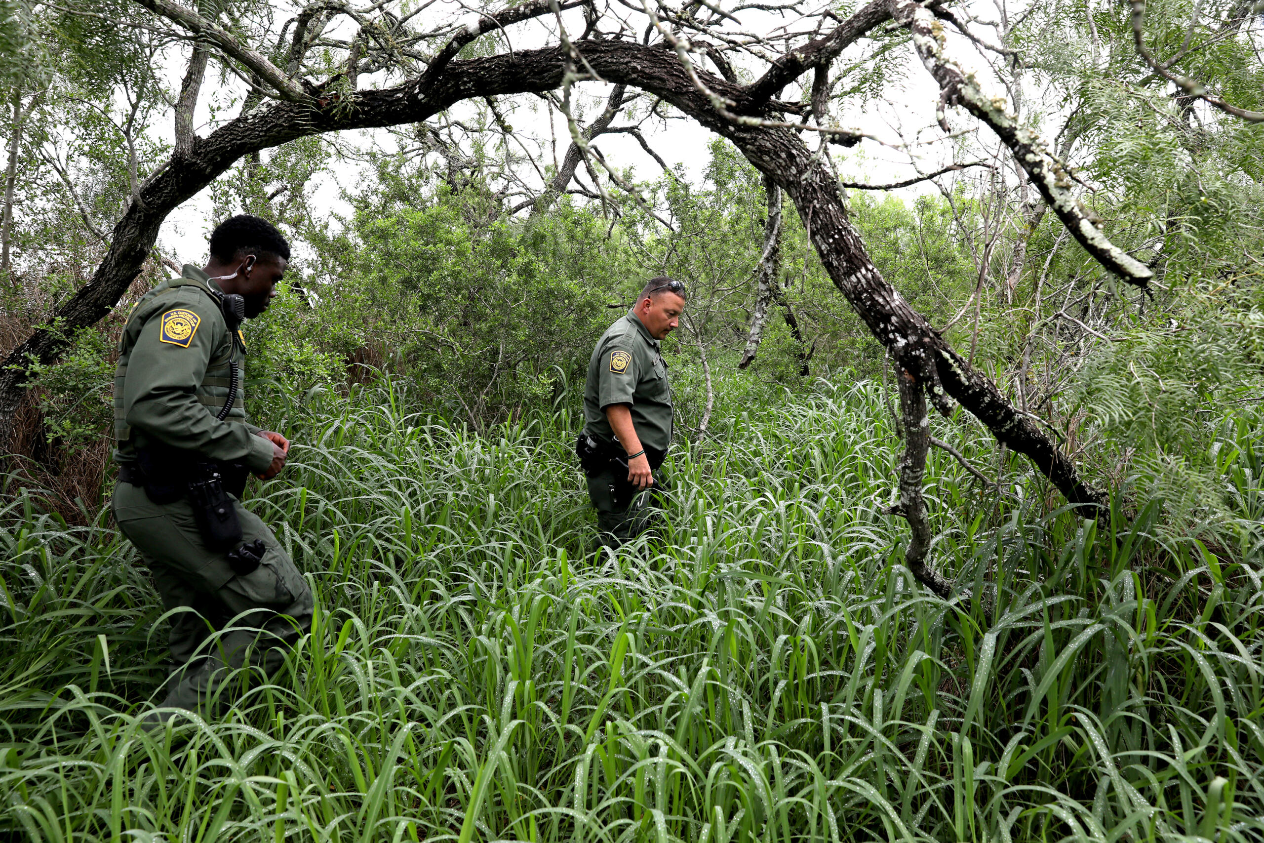 U.S. Customs and Border Protection Agents Ebenezar Oyenola, left, and Jaime Cavazos search for missing Honduran migrant Yoel Nieto Valladares, 25, on a south Texas ranch on June 3, 2021.