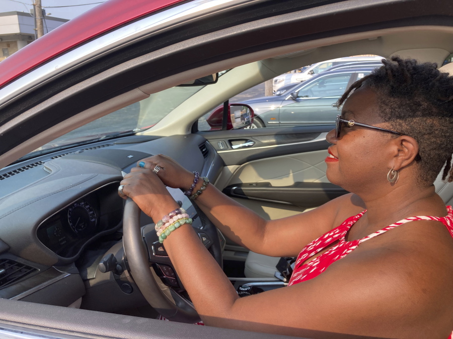 Jessica Pitts sits behind the wheel of a 2019 Lincoln MKC on the lot of Jack Demmer Lincoln in Dearborn, Mich., on Monday, July 19, 2021. Pitts bought the used car at the dealership.