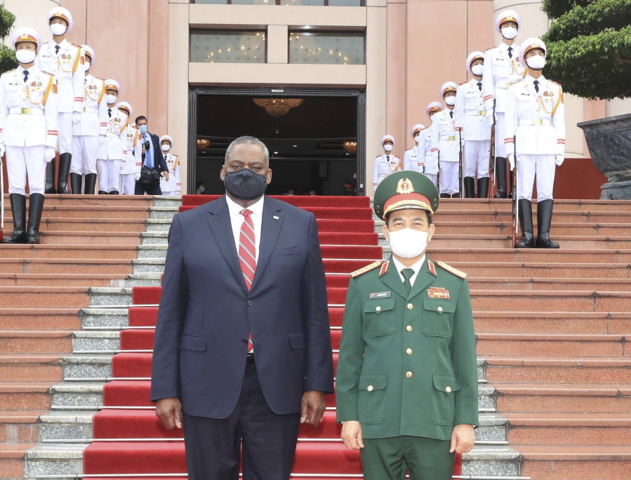U.S Defense Secretary Lloyd Austin and Vietnamese Defense Minister Phan Van Giang stand for a photo in Hanoi, Vietnam, Thursday, July 29, 2021. Austin is seeking to bolster ties with Vietnam, one of the Southeast Asian nations embroiled in a territorial rift with China, during a two-day visit.
