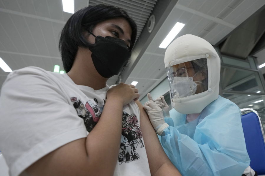 A health worker administers a dose of the AstraZeneca COVID-19 vaccine at the Central Vaccination Center in Bangkok, Thailand, Thursday, July 15, 2021. As many Asian countries battle against a new surge of coronavirus infections, for many their first, the slow-flow of vaccine doses from around the world is finally picking up speed, giving hope that low inoculation rates can increase rapidly and help blunt the effect of the rapidly-spreading delta variant.