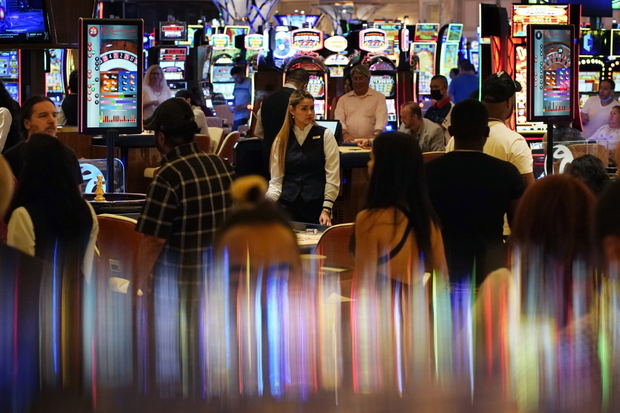 Crowds walk through the casino during the opening night of Resorts World Las Vegas on June 24 in Las Vegas. Las Vegas fully reopened and lifted restrictions on most businesses June 1.
