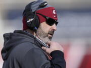 FILE - Washington State head coach Nick Rolovich looks on during the first half of an NCAA college football game against Utah in Salt Lake City, in this Saturday, Dec. 19, 2020, file photo. Rolovich has become the story of Pac-12 media day even though he won't be in attendance. Rolovich's announcement last week he has chosen not to receive a COVID-19 vaccination has divided his fan base and seemingly his school as one of the colleges requiring students and staff to be vaccinated before the start of classes this fall.