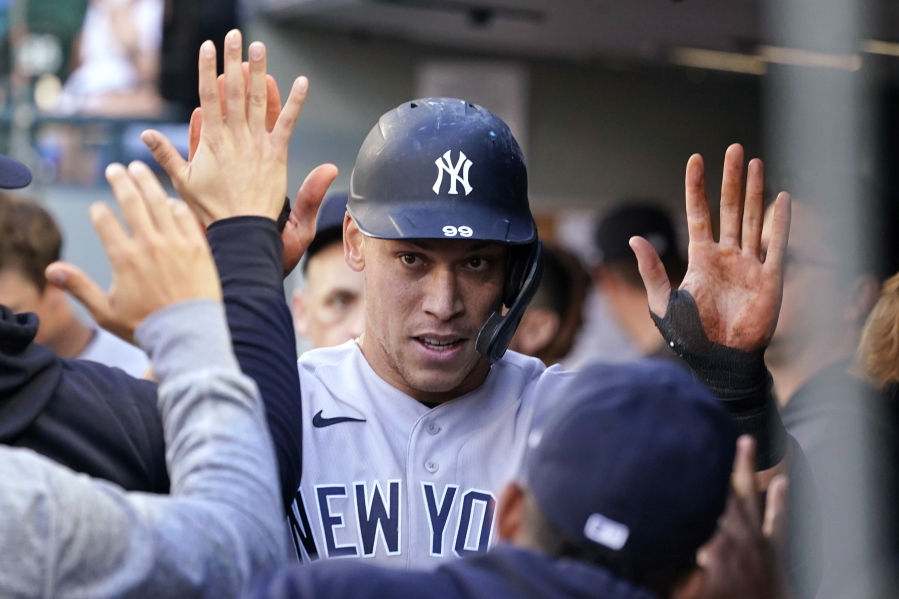 New York Yankees' Aaron Judge is congratulated after scoring against the Seattle Mariners during the first inning of a baseball game Wednesday, July 7, 2021, in Seattle.