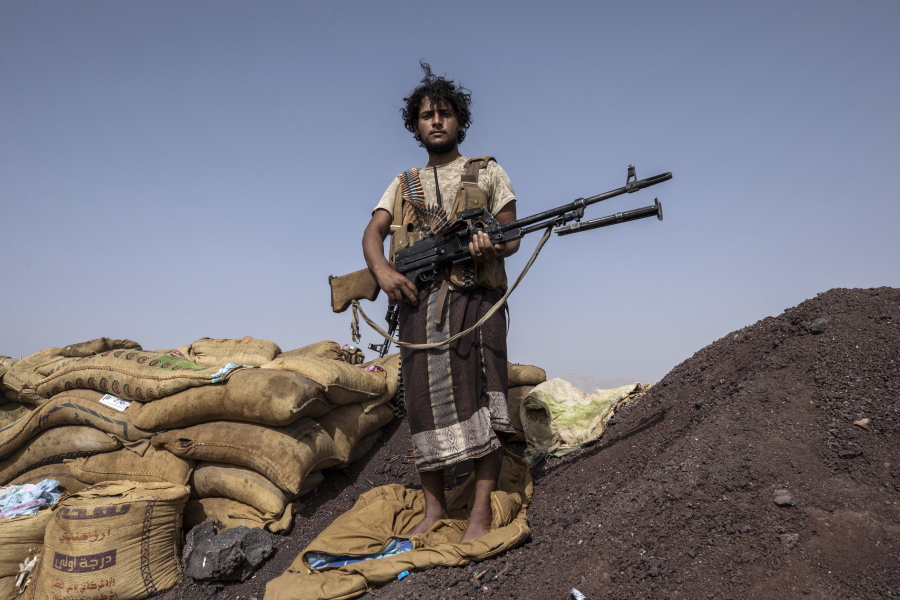 Yemeni fighter Hassan Saleh backed by the Saudi-led coalition stands for a photograph after clashes with Houthi rebels on the Kassara front line near Marib, Yemen, Sunday, June 20, 2021. Saleh and his younger brother Saeed, both in their early 20s, both in their early 20s, have been fighting alongside other government fighters and tribesman outside the oil-rich city of Marib against the months-long offensive by the Iranian-backed rebels. They say they need more weapons to push the attackers back.