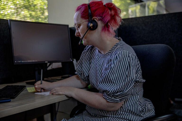 Crisis line phone volunteer Chessie Snider takes calls on June 29, 2021. House Bill 1477 will provide money to improve staffing at the state’s crisis call centers and will also give call centers better tools to connect people to treatment options.