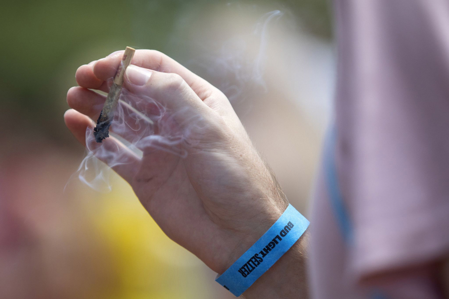 A festival goer smokes marijuana at Lollapalooza on July 29, 2021, in Chicago.