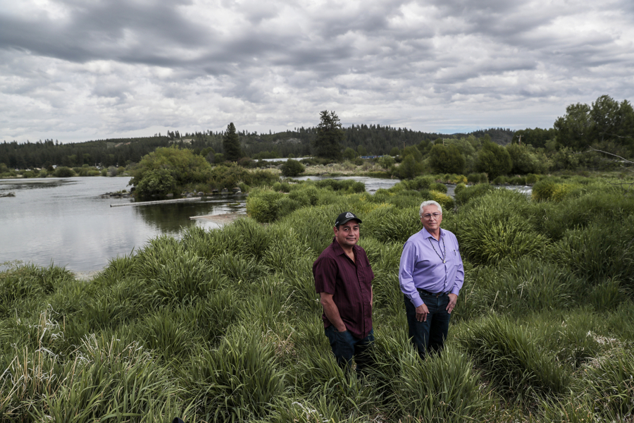 Council member Clayton Dumont, left, and tribal Chairman Don Gentry stand next to the Sprague River, which flows to Upper Klamath Lake.