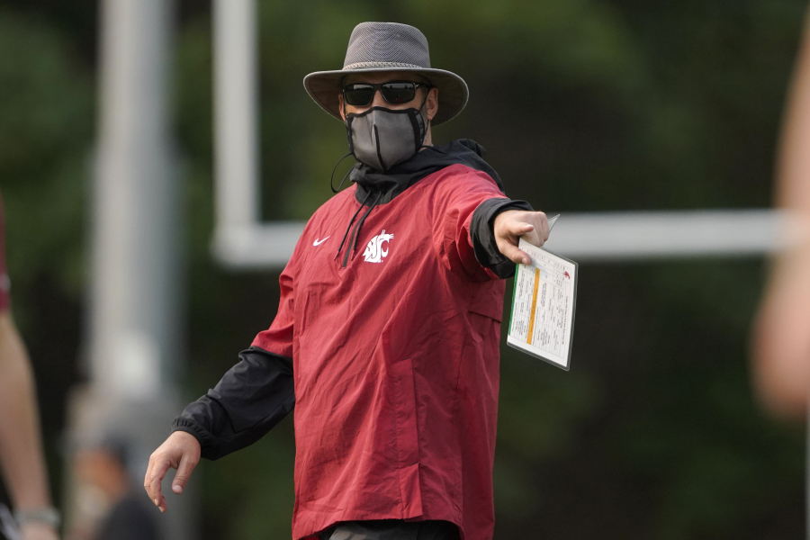 Washington State head coach Nick Rolovich wears a mask as he gives directions during a recent football practice. Rolovich remains the only unvaccinated head football coach in the Pac-12. (AP Photo/Ted S.
