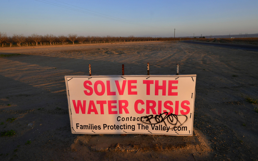 A sign calls for solving California's water crisis on the outskirts of Buttonwillow in California's Kern County on April 2, 2021, one of the top agriculture producing counties in the San Joaquin Valley where dairy, grapes, almonds, strawberries, and pistachios contribute billions to the economy each year. (Frederic J.