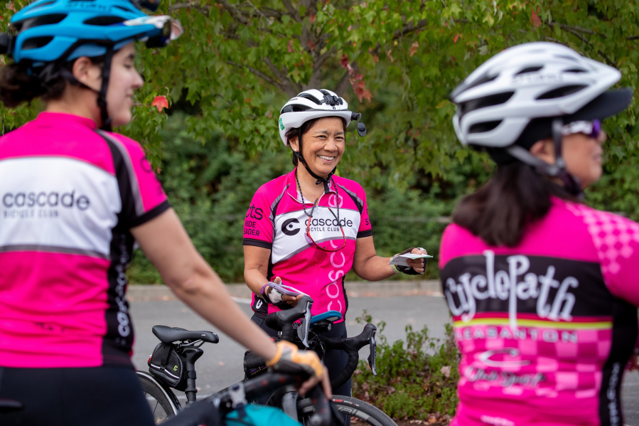 Cascade Bicycle Club ride leader Mary Hoshizaki speaks Aug. 18 to a group of cyclists before they head out for a ride in Redmond.