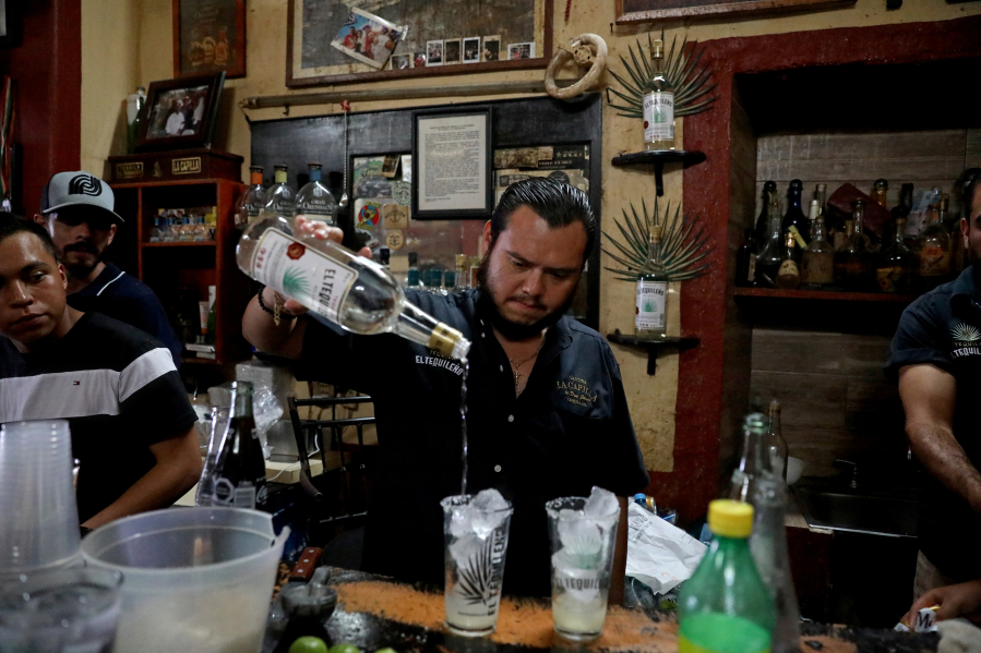Aaron de Jesus Mercado prepares a Batanga drink made with El Tequileno tequila at La Capilla de Don Javier cantina, more than 88 years in business, on July 24, 2021, in Tequila, Jalisco.