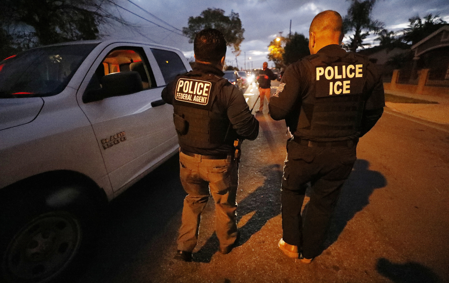 ICE agents apprehend someone in the early morning hours in Bell Gardens, California, in March 2020.