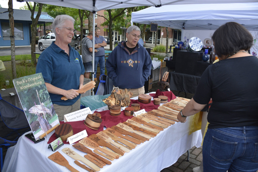 Visitors to the 2019 Washougal Art Festival browse the wares at a booth. This year's festival is Saturday in Reflection Plaza.