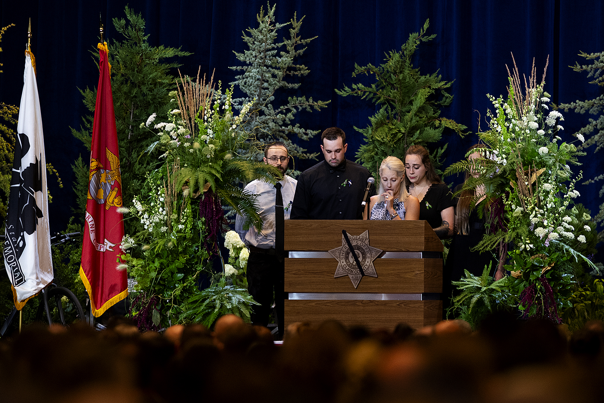 Family members of Sgt. Jeremy Brown including his wife, Jill Brown, at microphone, gather to honor his memory during his celebration of life at ilani casino Tuesday afternoon, Aug. 3, 2021. More than 2,500 people attended the standing room-only service.