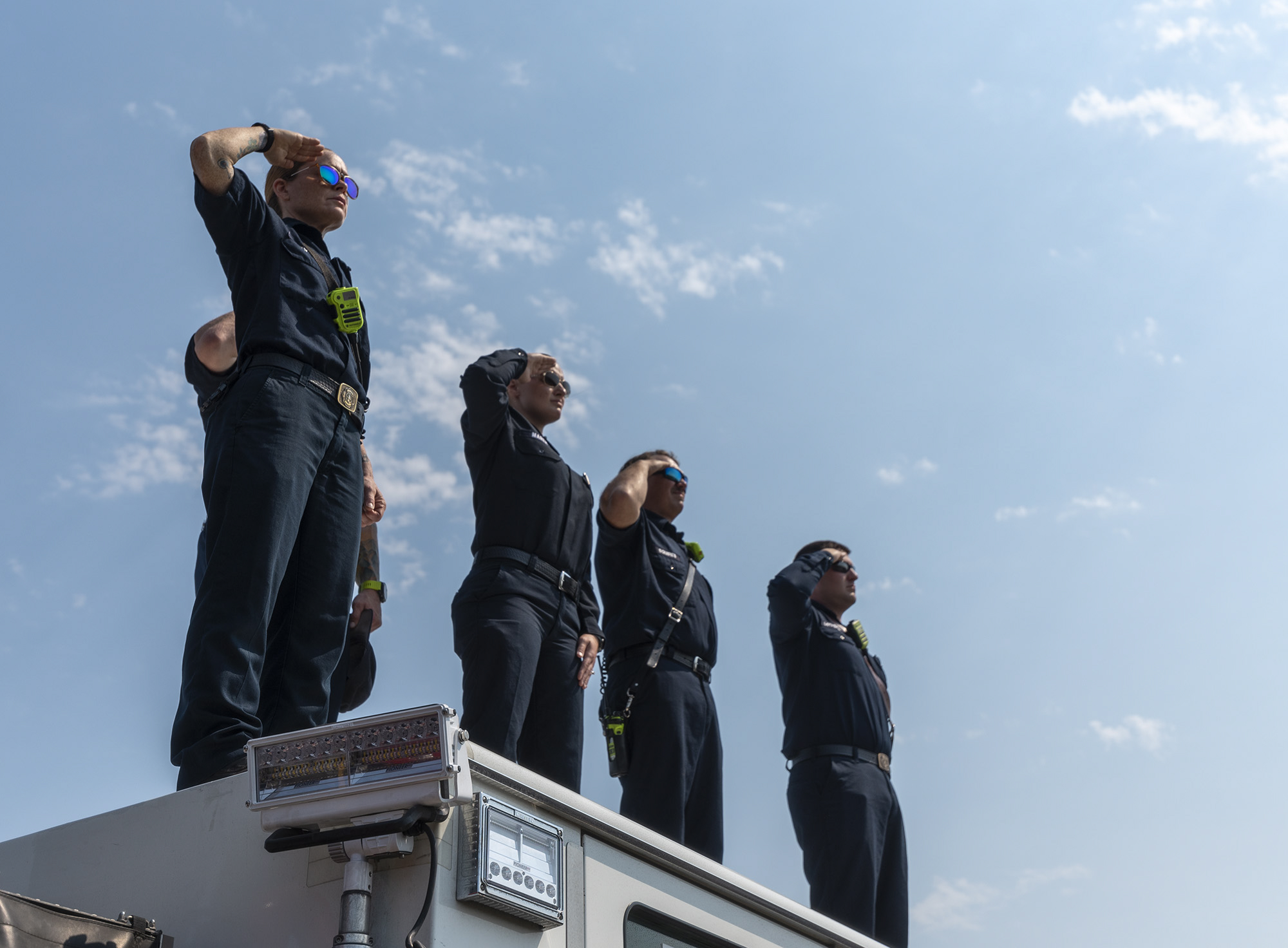 EMTÕs and firefighters from Clark County Fire District 6 stand atop a firetruck and salute as a funeral procession for Clark County Sheriff's Sgt. Jeremy Brown drives north on I-5 on Tuesday, Aug. 3, 2021, at the NE 139th Street overpass in Vancouver.