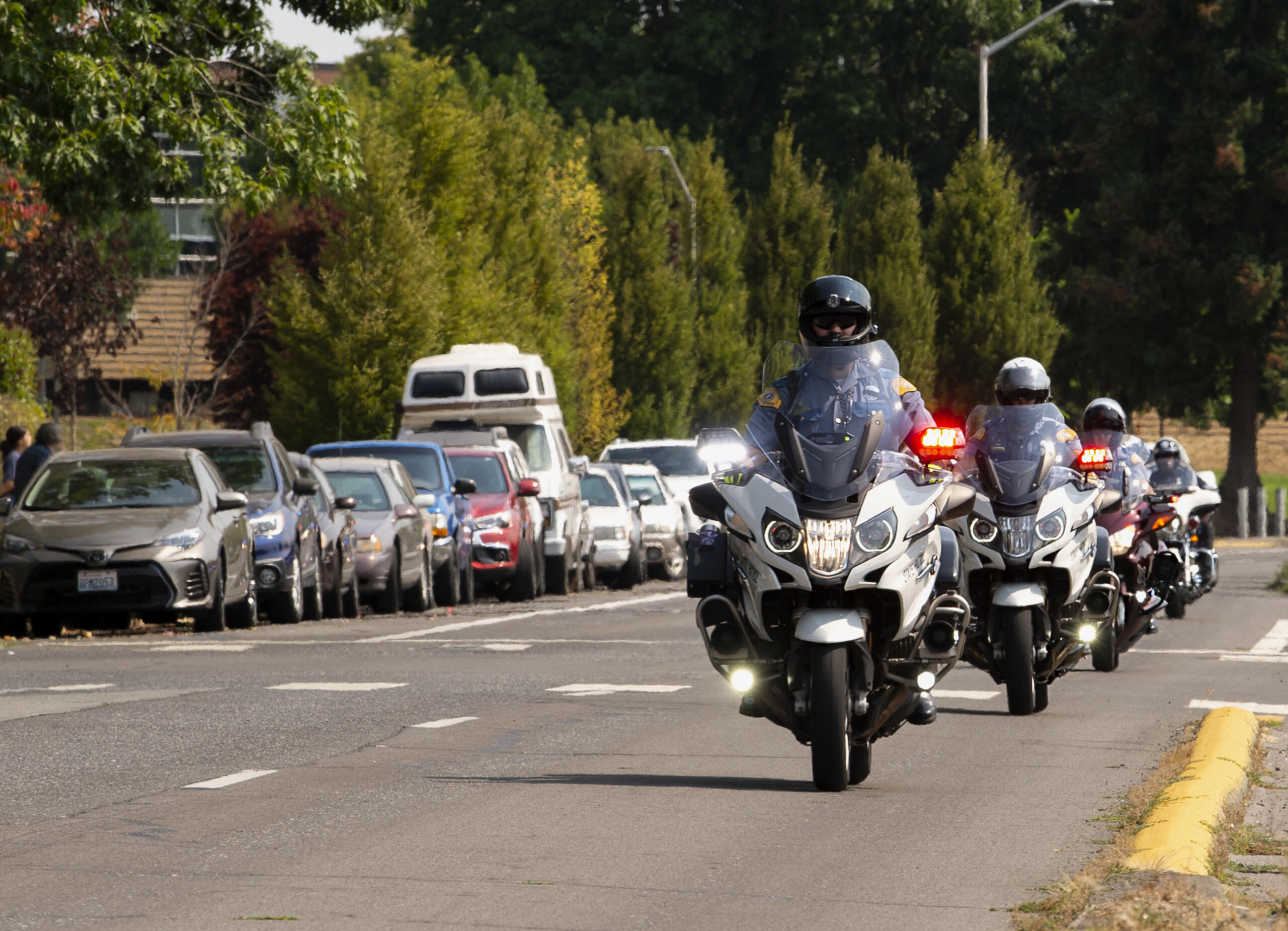 Officers on motorcycles start the procession preceding the funeral of Clark County Sheriff's Sgt. Jeremy Brown on Tuesday, Aug. 3, 2021, at Clark College. Brown was fatally shot on July 23 while conducting surveillance on a group of people at an east Vancouver apartment complex. Hundreds of law enforcement vehicles took place in the procession up I-5 to ilani casino in La Center. It took 15 minutes for the hundreds of vehicles to vacate the Clark College lot.