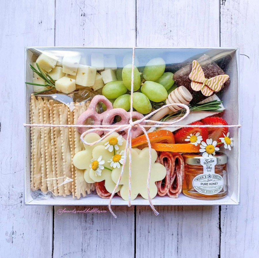 Charcuterie, including this elegant offering from Board and Bubbles, can elevate a picnic from fun to memorable.