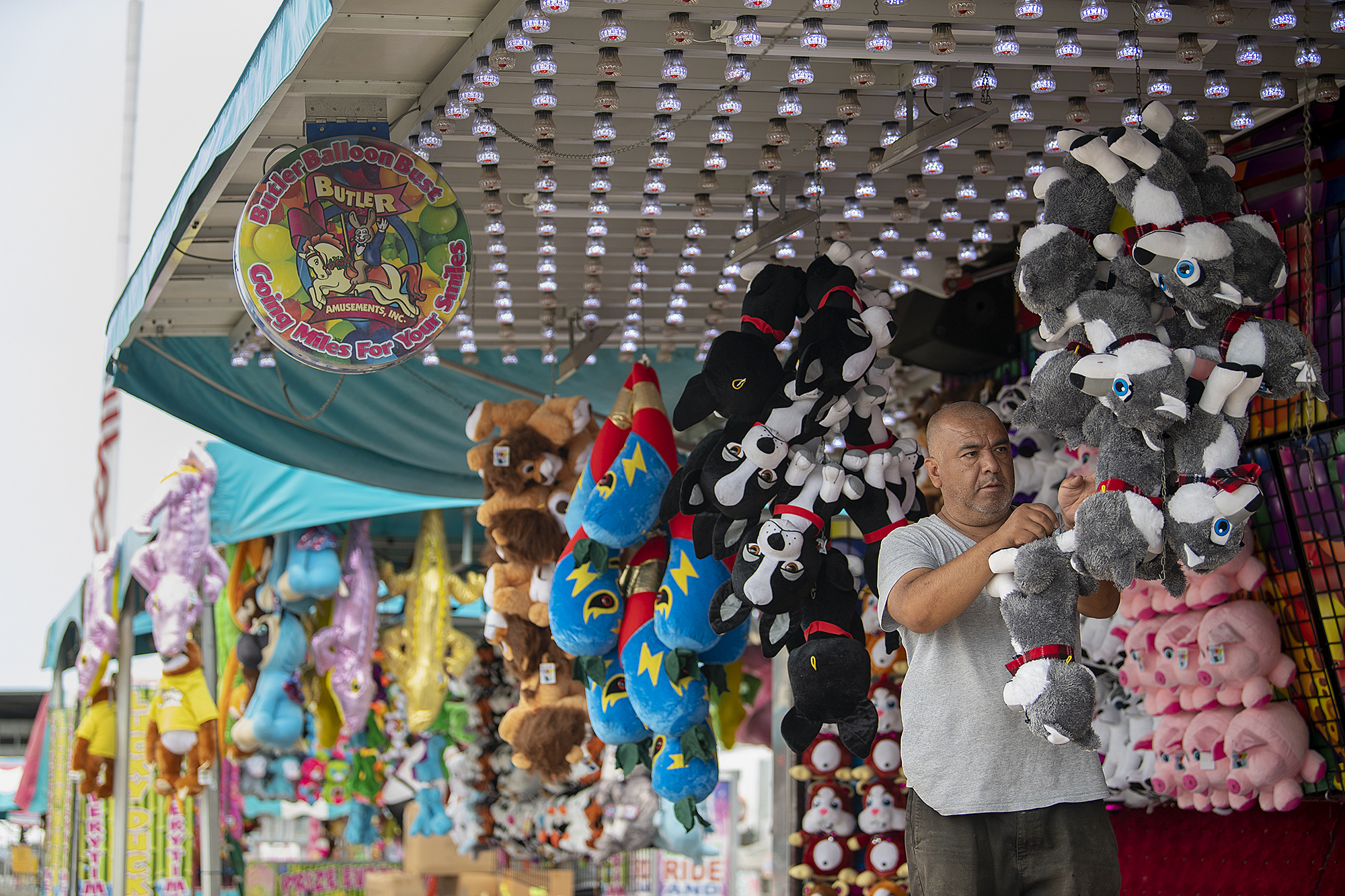 Alejandro Trejo of Butler Amusements sets out some of the prizes at the carnival.