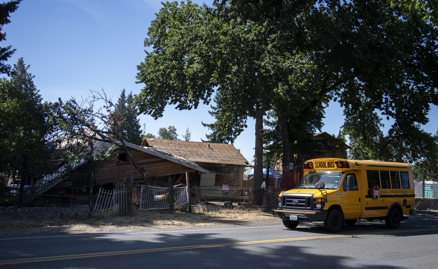 The house at 6114 N.E. 112th Ave., dubbed the "meth mansion," is seen Tuesday morning partly demolished. Code violations and nuisance complaints over the property have plagued the neighborhood for years. Demolition is scheduled to be finished by Aug. 20.