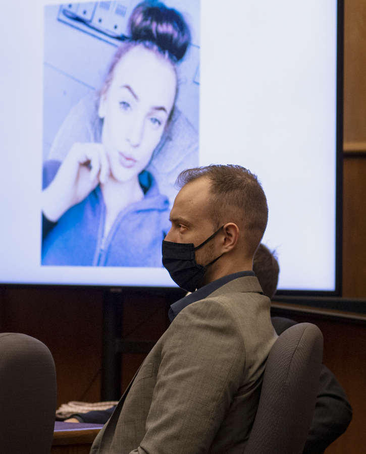 Defendant David Bogdanov listens to the prosecution's opening statement, with a photo of 17-year-old Nikki Kuhnhausen on a projection screen behind him, at his murder trial Tuesday morning in Clark County Superior Court. Bogdanov is accused of strangling the transgender teen.