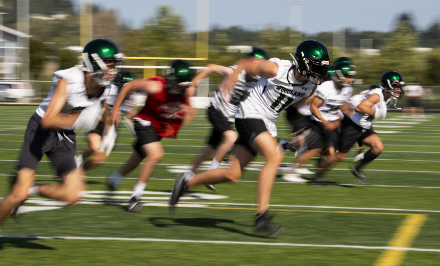 Woodland junior Justin Philpot sprints toward the sideline during a defensive back drill as high school football started its first fall season since 2019 on Wednesday, Aug. 18, 2021, at Woodland High School. Football practices resumed Wednesday for all Clark County teams with the first games just 16 days away.