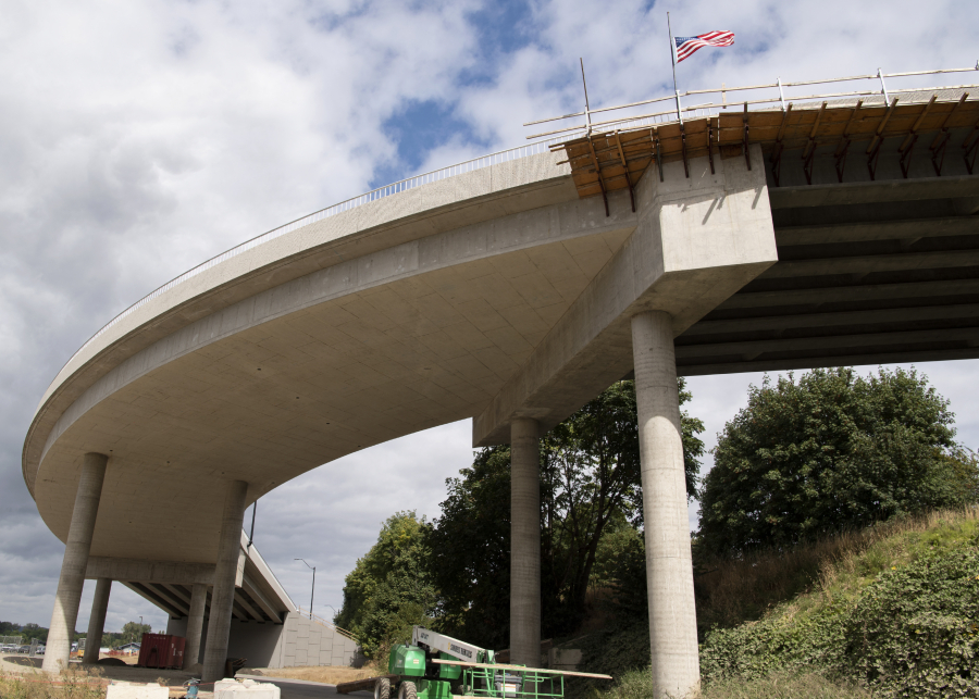 An American flag blows in the wind on the Pioneer Street rail overpass on Tuesday in Ridgefield. The nearly finished overpass connects downtown with the boat launch area to the west of the railway.