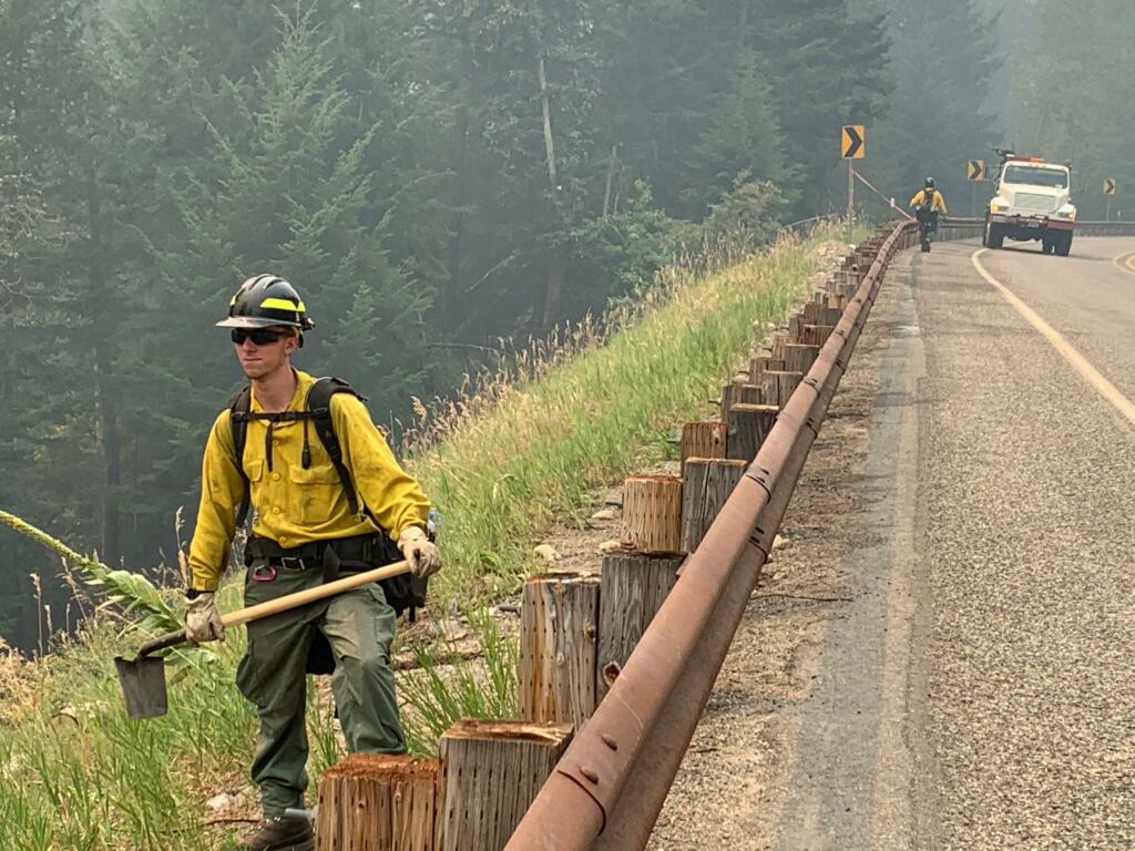 A firefighter waits on Highway 20 as the Cedar Creek fire burns through central Washington in late July. (U.S.