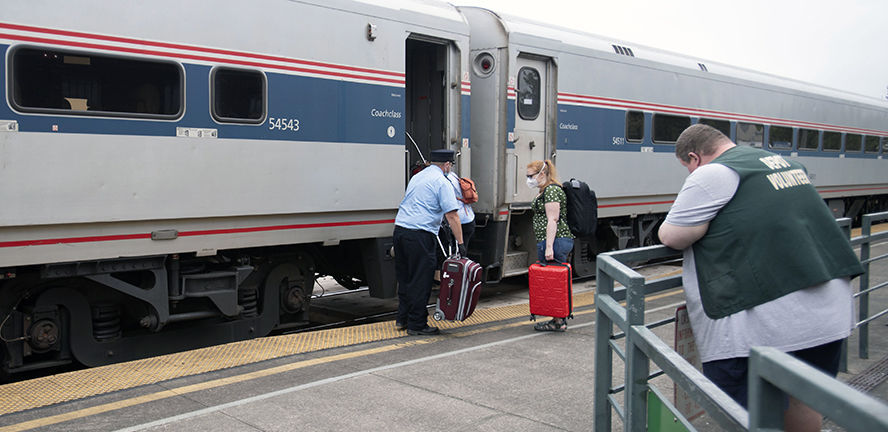 Passengers board the southbound Amtrak Cascades train at the Kelso station on Monday.