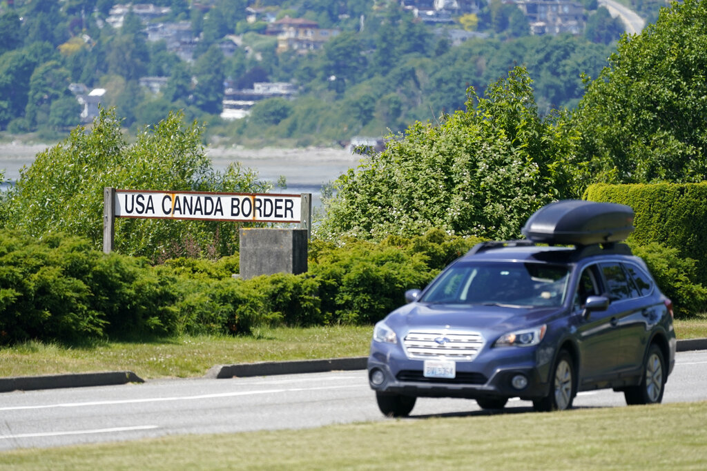 FILE - In this June 8, 2021, file photo, a car heads into the U.S. from Canada at the Peace Arch border crossing in Blaine, Wash. Canada is lifting its prohibition Monday, Aug. 9, on Americans crossing the border to shop, vacation or visit, but the United States is keeping similar restrictions in place for Canadians. The reopening Monday is part of a bumpy return to normalcy from COVID-19 travel bans.
