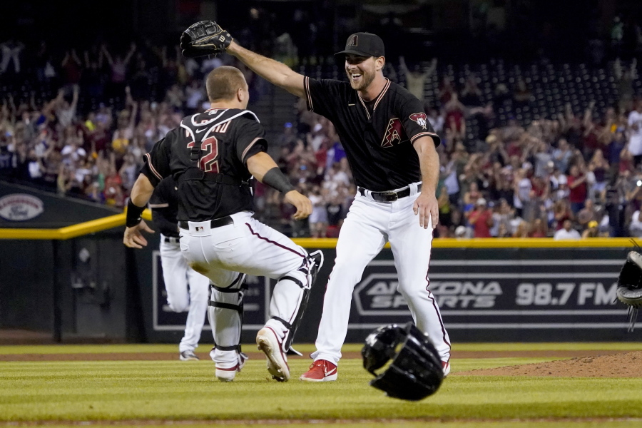 Arizona Diamondbacks starting pitcher Tyler Gilbert, right, celebrates after his complete game no hitter against the San Diego Padres with catcher Daulton Varsho, Saturday, Aug. 14, 2021, in Phoenix. It was Gilbert's first career start. The Diamondbacks won 7-0.