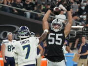 Las Vegas Raiders linebacker Tanner Muse (55) knocks down a pass thrown by Seattle Seahawks quarterback Geno Smith (7) during the first half of an NFL preseason football game, Saturday, Aug. 14, 2021, in Las Vegas.