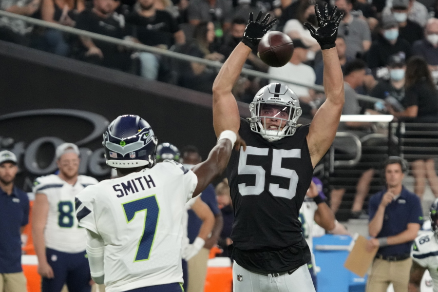 Las Vegas Raiders linebacker Tanner Muse (55) knocks down a pass thrown by Seattle Seahawks quarterback Geno Smith (7) during the first half of an NFL preseason football game, Saturday, Aug. 14, 2021, in Las Vegas.