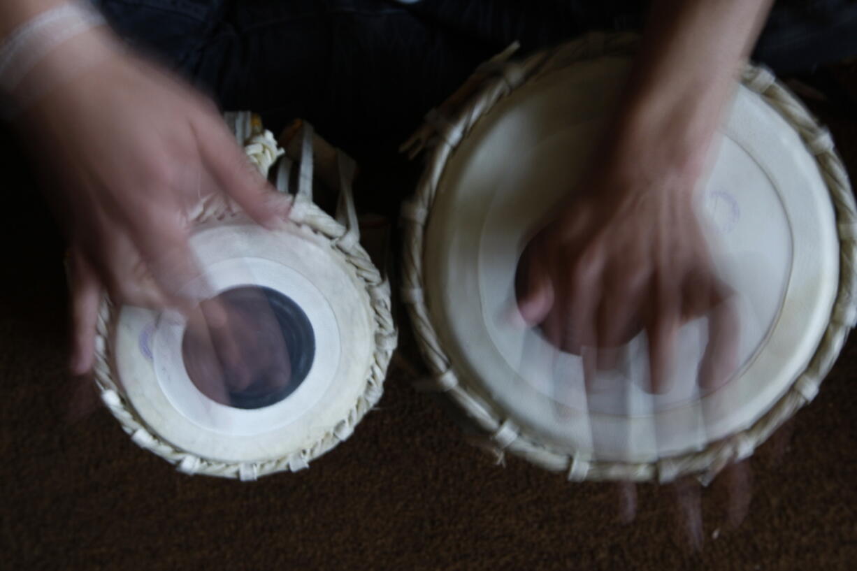 FILE - In this May 11, 2010 file photo, a student learns to play the tabla at the Afghan National Institute of Music, ANIM, in Kabul, Afghanistan. A few years after the Taliban were ousted in 2001, and with Afghanistan still in ruins, Ahmad Sarmast left his home in Melborne, Australia where he had sought asylum in the 90s, on a mission: to revive music in the country of his birth. The music school Sarmast founded was a unique experiment in inclusivity for the war-ravaged nation -- with orphans and street kids in the student body.