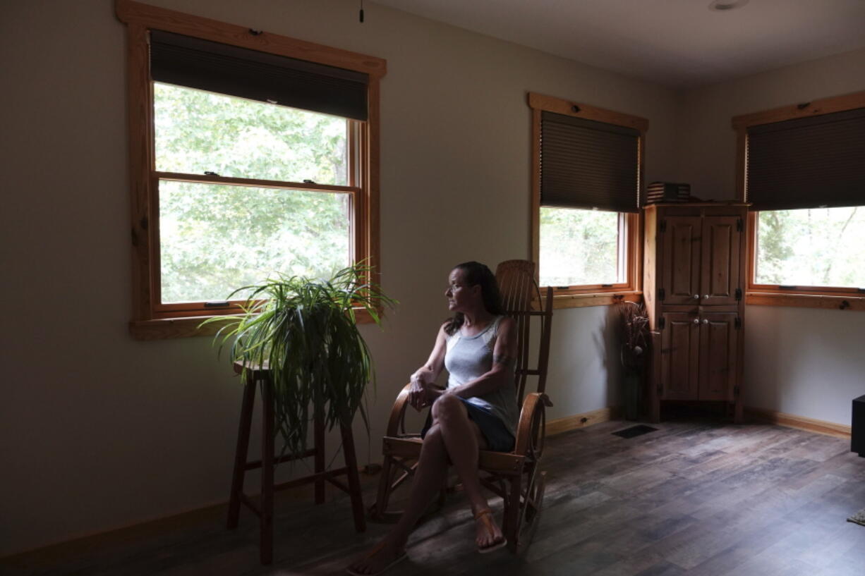 Gretchen Catherwood sits in her home in Springville, Tenn., on Wednesday, Aug. 18, 2021. Her son, 19-year-old Alec, was killed in Afghanistan fighting the Taliban in 2010. She and her husband are creating a retreat space, Darkhorse Lodge, for veterans up the road from their home.