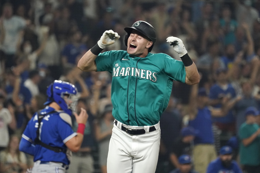 Seattle Mariners' Jarred Kelenic reacts to drawing a bases-loaded walk in the ninth inning to drive in the winning run in a baseball game against the Toronto Blue Jays on Friday, Aug. 13, 2021, in Seattle. The Mariners won 3-2.