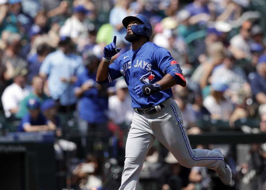 Toronto Blue Jays' Teoscar Hernandez points skyward after hitting a solo home run off a pitch by Seattle Mariners starter Logan Gilbert in the second inning on Sunday.