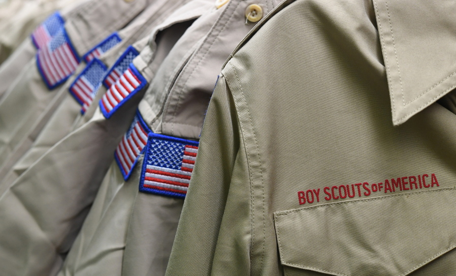 FILE - In this Feb. 18, 2020, file photo, Boy Scouts of America uniforms are displayed in the retail store at the headquarters for the French Creek Council of the Boy Scouts of America in Summit Township, Pa.  Attorneys recently reached a tentative agreement that could help pave the way for the Boy Scouts of America to exit bankruptcy.  A Delaware judge has set a Thursday, Aug. 12, 2021 hearing on a proposed $850 million agreement between the Boy Scouts and attorneys representing about 70,000 child sex abuse claimants.