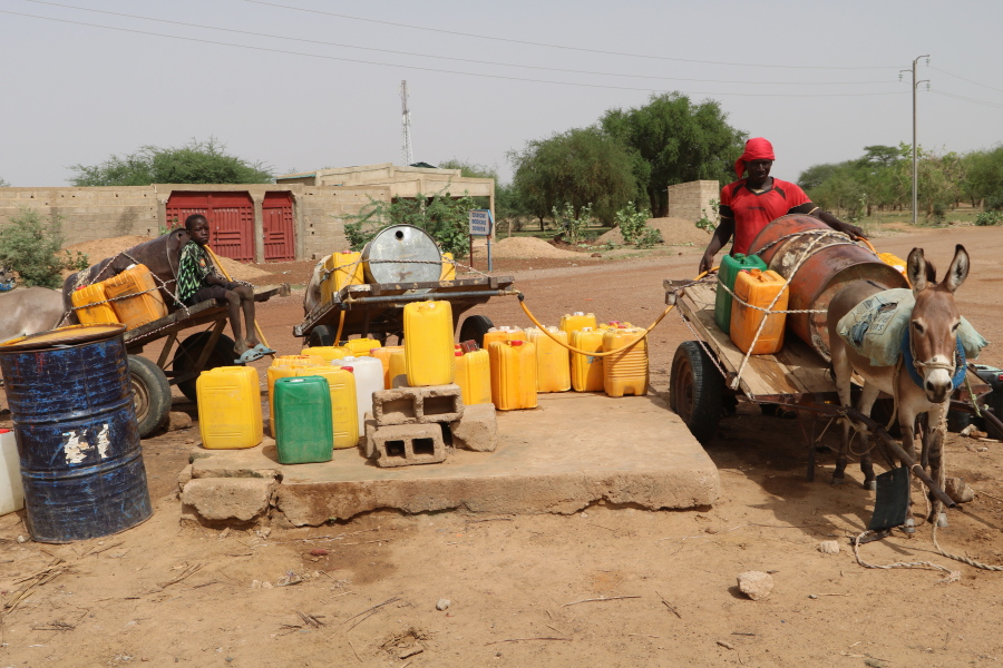 Residents fill up water containers in Dori, Burkina Faso, Wednesday July 7, 2021. Violence by fighters linked to al-Qaida and the Islamic State in Burkina Faso is on the rise, and with it, so is the recruitment of child soldiers, according to reports.