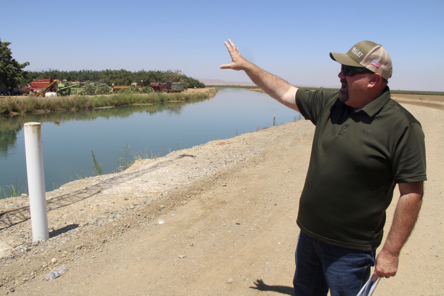 Kevin Spesert, public affairs and real estate manager for the Sites Project Authority, points out the main canal of the Glenn Colusa Irrigation District, on Friday, July 23, 2021, near Sites, Calif.