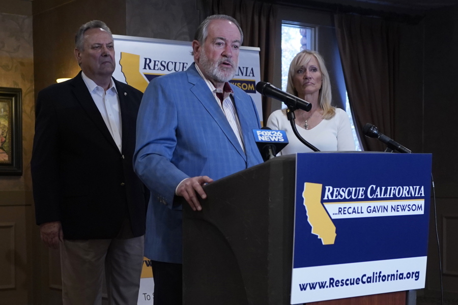 Former Arkansas Gov. Mike Huckabee, a Republican, speaks in support of the recall of Calif., Gov. Gavin Newsom Calif., Friday, July 30, 2021. Huckabee, flanked by former California Secretary of State Bill Jones, a Republican, and Anne Dunsmore, campaign manager of the pro-recall group Rescue California, attended a fund raising breakfast for the recall campaign. While Democratic registration almost doubles that of Republicans in the state, Democratic Party leaders fear Republicans appear more eager to vote in the Sept. 14 election.