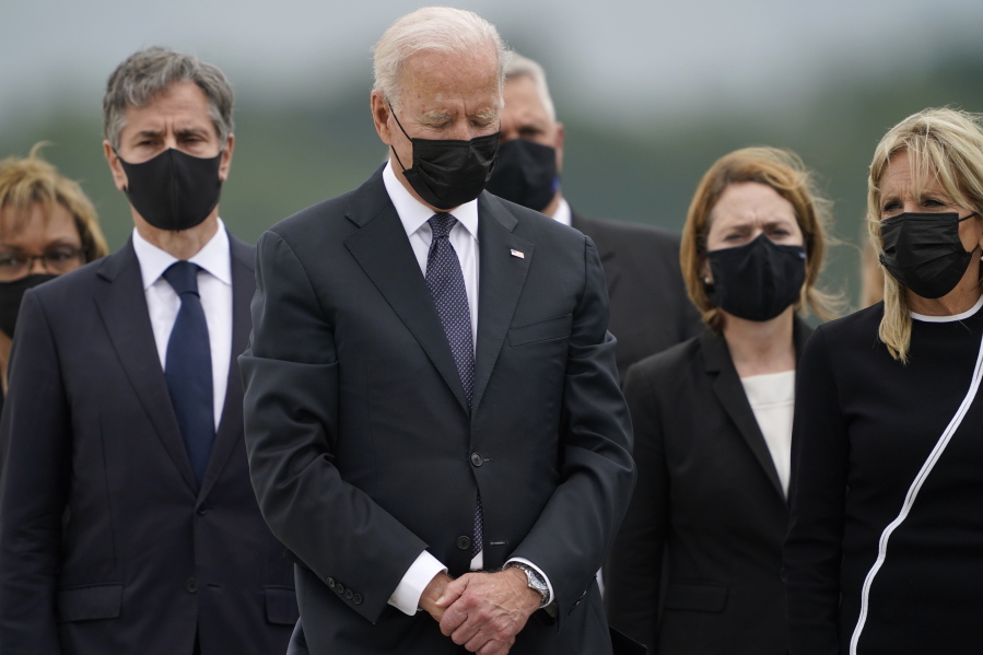President Joe Biden bows his head as first lady Jill Biden, right, and Secretary of State Antony Blinken, left, watch during a casualty return at Dover Air Force Base, Del., Sunday, Aug. 29, 2021, for the 13 service members killed in the suicide bombing in Kabul, Afghanistan, on Aug. 26.