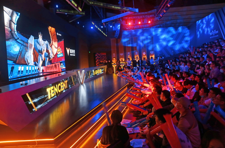 Fans watch the match of the 2020 League of Legends World Championship televised on a screen at a Tencent V-station in Shanghai, China, Oct. 31, 2020. Hugely popular online games and celebrity culture are the latest targets in the ruling Communist Party's campaign to encourage China's public to align their lives with its political and economic goals.